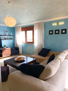 a living room with a couch and a table at R&G Serenity Apartment in Ližnjan