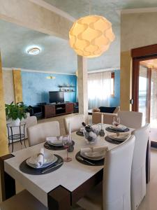 a dining room and living room with a table and chairs at R&G Serenity Apartment in Ližnjan