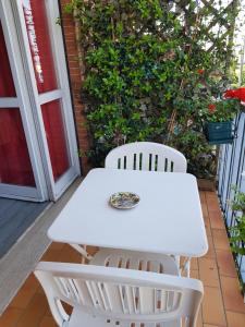 a white table and two white chairs on a porch at Guesthouse La Rocca in Grassobbio