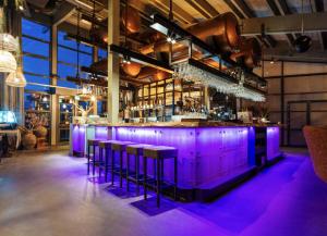 a bar with purple lighting in a restaurant at Studio Waterfront | 2 Pers. in Ouddorp