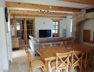 a living room with a table and a couch at La Maison du Bonheur in Jaujac
