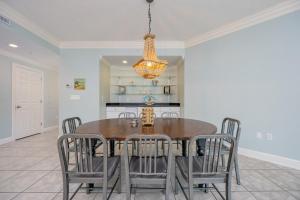 a dining room with a table and chairs at Phoenix on the Bay 1326 condo in Orange Beach