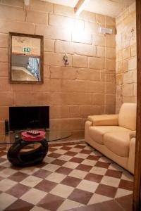 a living room with a couch and a fireplace at Senglea Charming 2BDR Townhouse in Senglea