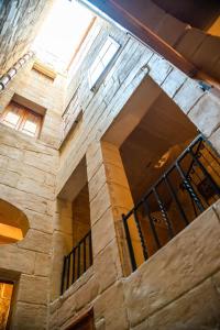 a stone building with a staircase in a building at Senglea Charming 2BDR Townhouse in Senglea