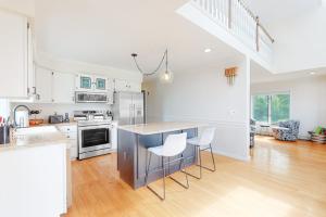 a kitchen with a counter and chairs in a room at Nubble's Perch in York