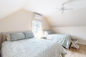 a bedroom with two beds and a window at Nubble's Perch in York