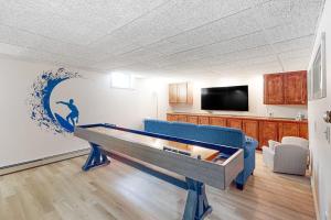 a room with a pool table with a wave painted on the wall at Nubble's Perch in York