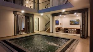 a swimming pool in the middle of a house at Zenna villa long Hải in Bà Rịa