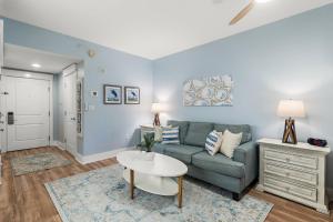 a living room with a couch and a table at Grand Sandestin 2210 in Destin