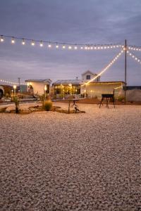 a bench sitting in the middle of a beach with lights at Deem view in Al Ain