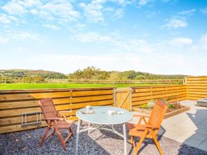 a patio with a table and two chairs and a fence at 1 Bed in Conwy oc-95222 in Conwy