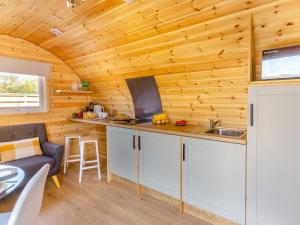 a kitchen and living room in a log cabin at 1 Bed in Conwy oc-95222 in Conwy