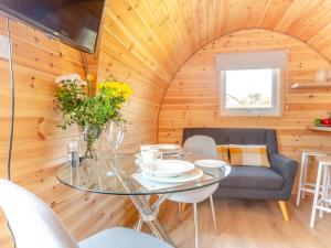 a dining room with a glass table in a tiny house at 1 Bed in Conwy oc-95222 in Conwy +14 photos