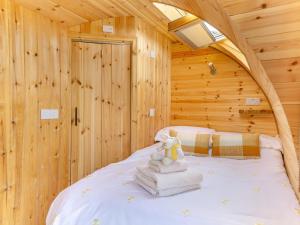 a bedroom with a bed in a log cabin at 1 Bed in Conwy oc-95222 in Conwy