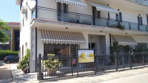 a building with a fence in front of it at Relax e Mare a Bellaria in Bellaria-Igea Marina
