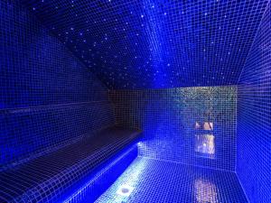 a blue room with a tub with blue lights at NoTwenty9 Bar and Restaurant in Burnham Market