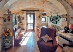 a living room with a couch and a stone fireplace at La grotta di NiMa in Pretoro