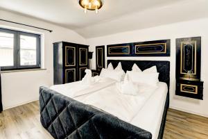 a bedroom with a large bed with white sheets at Das Bergnest Maishofen in Maishofen