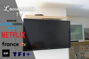 a flat screen tv sitting on top of a wall at L'accampado in Arles +10 photos