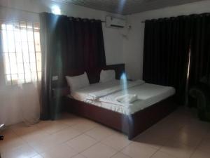 a small bedroom with a bed in a room at Lifeconcep apartment and lodge in Ibadan