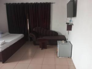 a living room with a couch and a television at Lifeconcep apartment and lodge in Ibadan