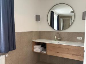 a bathroom with a sink and a mirror at Pension Schiessling in Anif