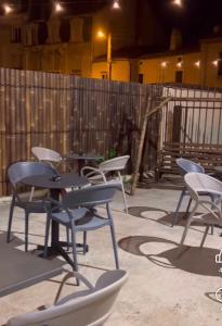 a group of chairs and tables on a patio at Chambre Double et Lits Superposés in Toul