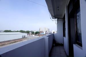 a balcony of a building with a view of a city at Tajiva Stay in Agra