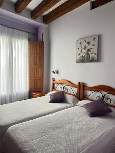a bedroom with two beds and a window at San Miguel in Segovia