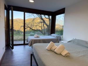 a bedroom with two beds and a large window at Chalet con piscina Gondomar in Gondomar +41 photos