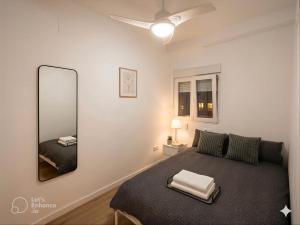 a bedroom with a bed and a large mirror at Dulces Sueños Amistad in Valencia +5 photos