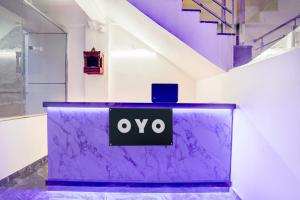 a purple table with the oo sign on it at HOTEL O SAMRAT INN in Prayagraj