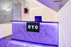 a purple counter with the oo sign on it at HOTEL O SAMRAT INN in Prayagraj