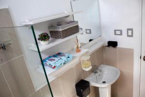 a bathroom with a sink and a toilet and a mirror at Kirara's House in Chanmico +8 photos