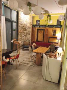 a living room with a table and chairs at 1920's Rooms & Beds in Kalamata
