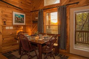 a wooden dining room with a table and chairs at Alpine Joy in Townsend