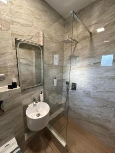 a bathroom with a sink and a shower at Αφροδίτη Hotel in Néon Rýsion