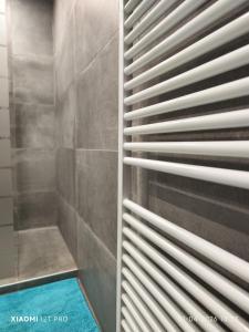 a bathroom with a shower with wooden blinds at Casa 28 in Kapelle-op-den-Bos