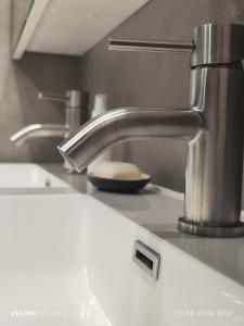 a kitchen sink with a chrome faucet at Casa 28 in Kapelle-op-den-Bos +12 photos