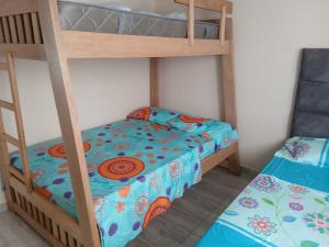 a bedroom with two bunk beds and a bed at Apartamento Ferchostour in Dosquebradas