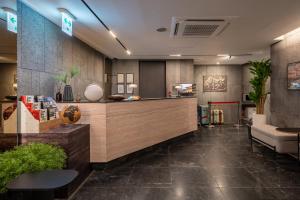 a hotel lobby with a reception desk and a counter at Nesto Hongdae in Seoul