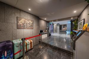 a hallway with suitcases lined up against a wall at Nesto Hongdae in Seoul