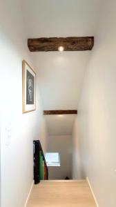 a room with white walls and wooden beams at Penthouse Apartment with Balcony in City Centre and Private Parking in Tórshavn