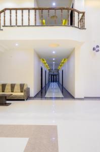 a hallway with a staircase and a couch in a building at Hotel Pushkar Legacy in Pushkar