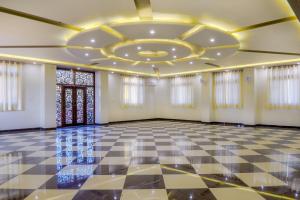a room with a ceiling and a checkerboard floor at Hotel Pushkar Legacy in Pushkar