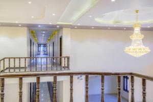 a staircase in a building with a chandelier at Hotel Pushkar Legacy in Pushkar