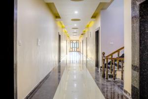 a hallway with white walls and yellow ceilings at Hotel Pushkar Legacy in Pushkar
