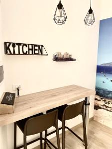 a dining room with a wooden table and two chairs at Casa dei mulini in Favignana