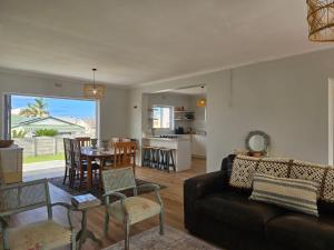 a living room with a couch and a table at Graatjie in Kleinmond