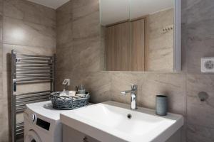 a bathroom with a sink and a mirror at Artemida Beach Apartment 2 in Artemida +18 photos